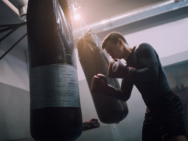 Beginner boxer practicing on the heavy bag