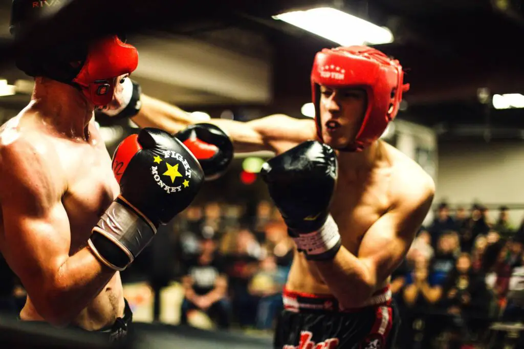 Two boxers sparring and landing head strikes