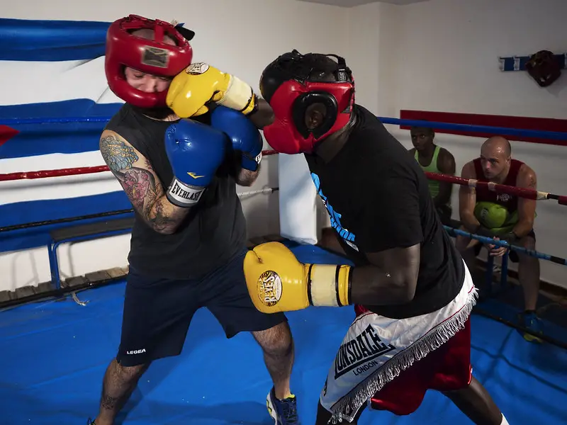 Two boxing students sparring while wearing a protective gear