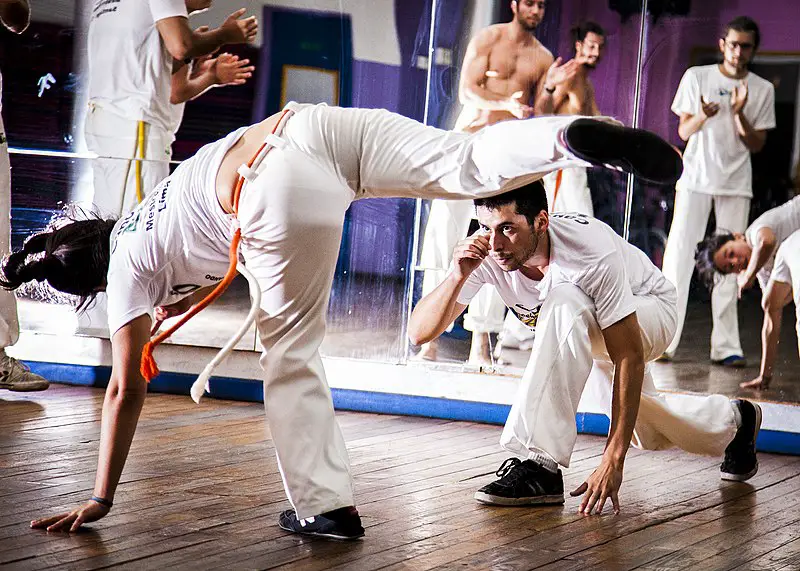 Two capoeira students practicing moves