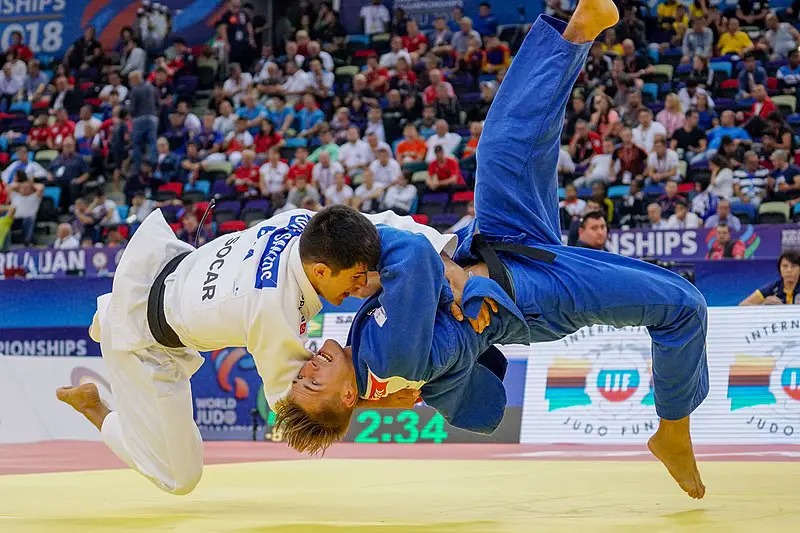 Judoka executing a powerful throw in competition