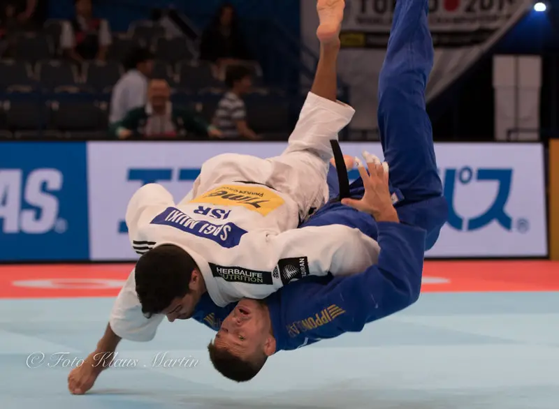 Judoka executing a powerful judo throw in competition