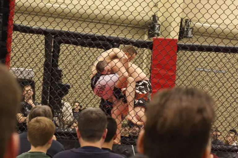 MMA fighter attempting a single leg takedown in an MMA match