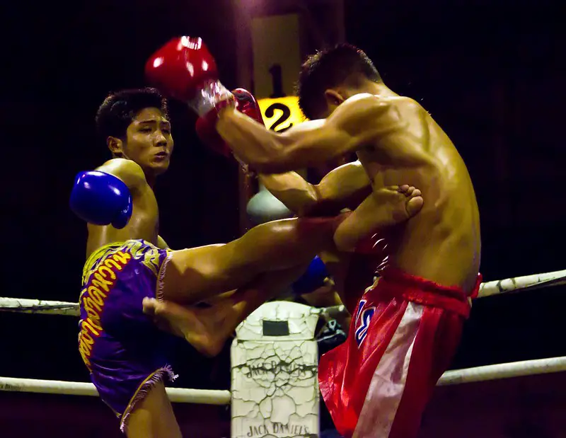 Muay Thai fighter landing a body kick