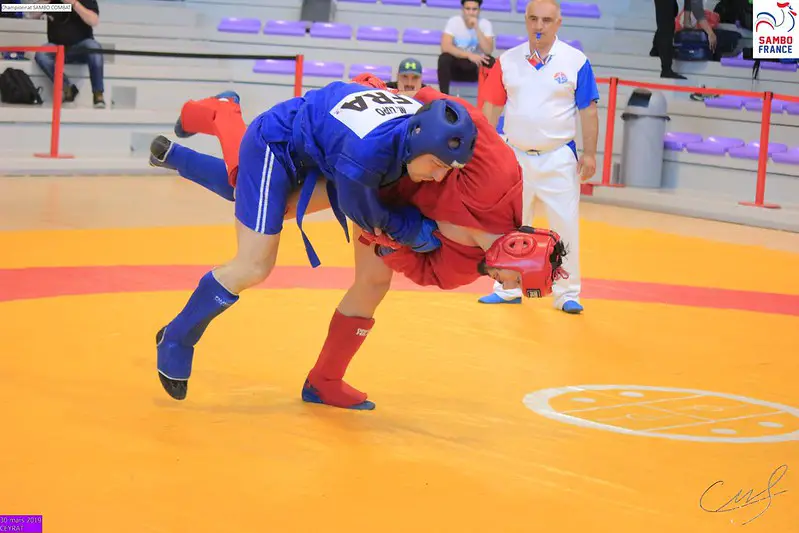 Sambo fighter taking his opponent down to the ground using a throw